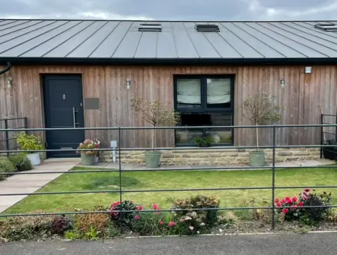 Converted barn front garden seen from the road before redesign